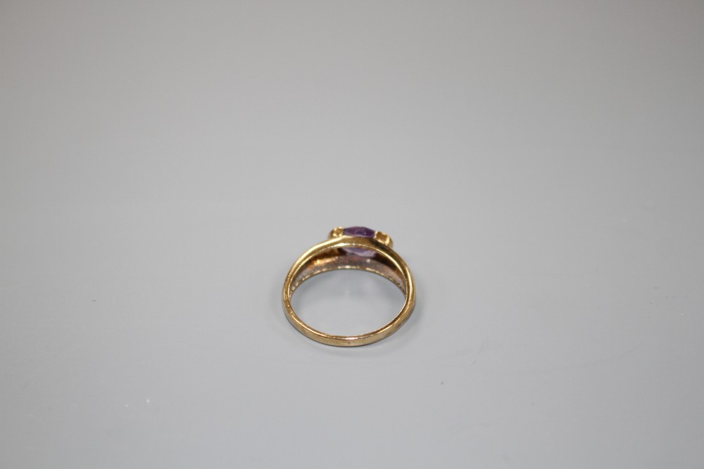 A modern 9ct gold and oval cut amethyst set ring, size P, gross weight 2.3 grams.